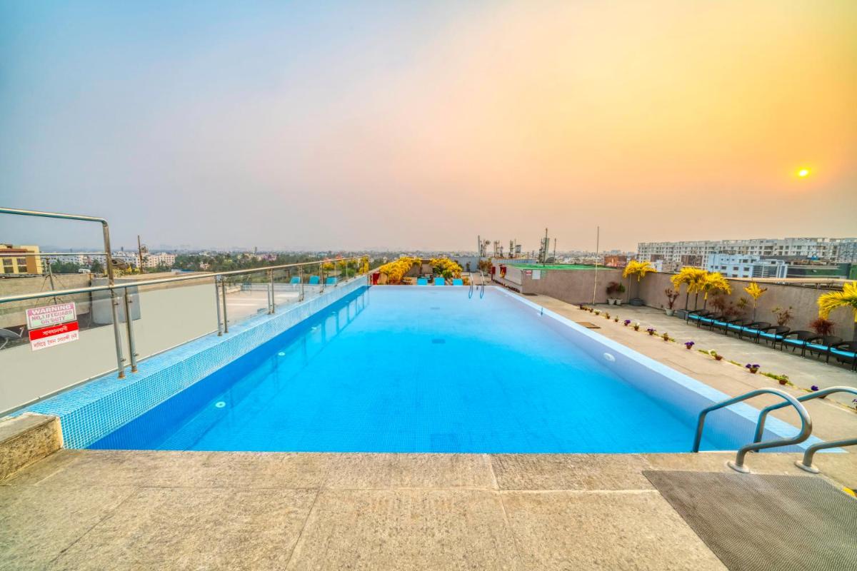 a swimming pool on the roof of a building at Holiday Inn Kolkata Airport by IHG in Kolkata
