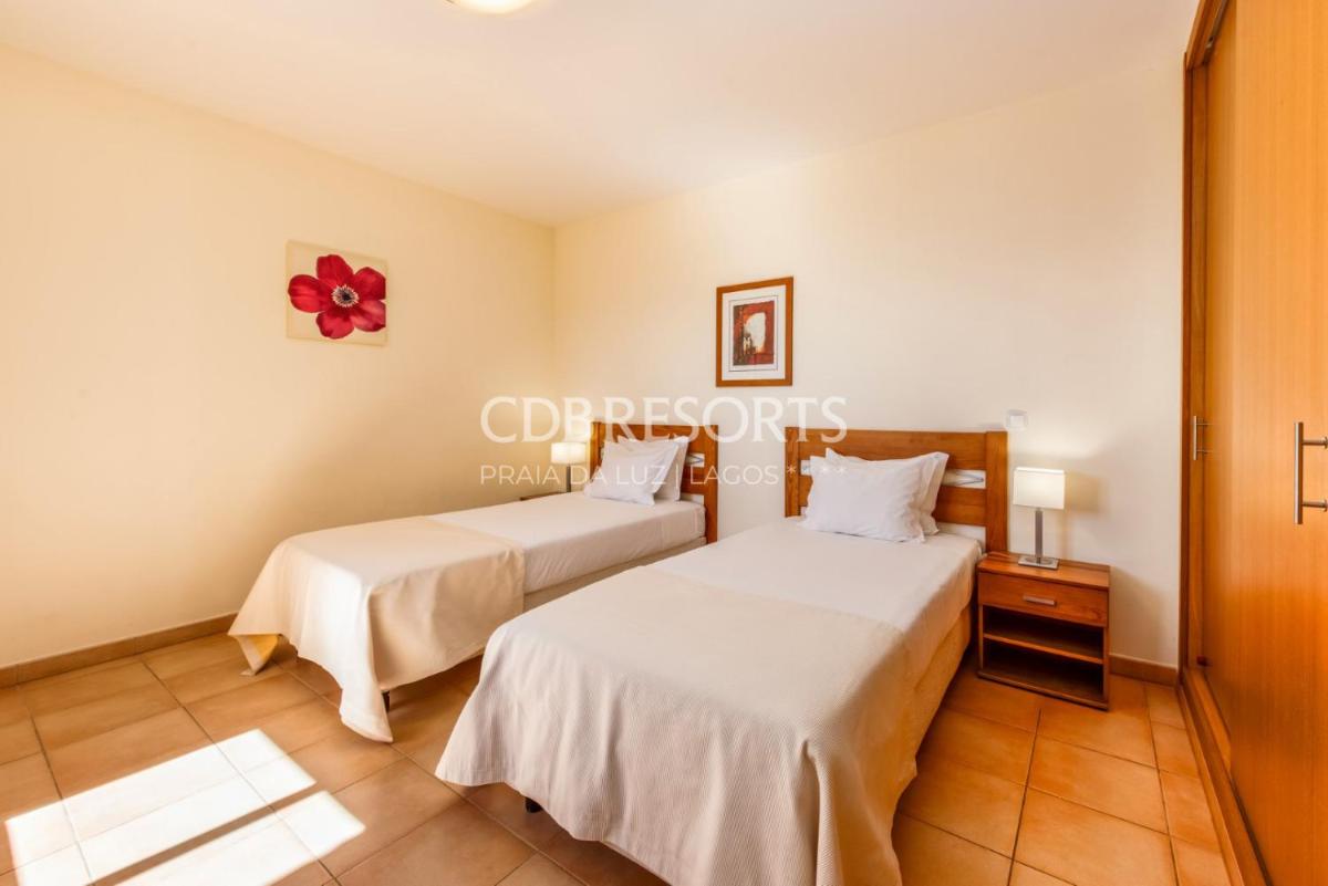 Uma cama ou camas num quarto em Estrela da Luz Resort