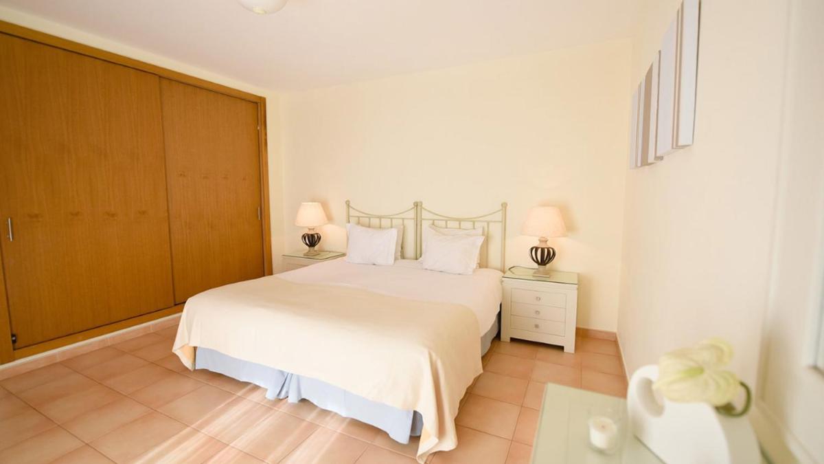 Uma cama ou camas num quarto em Estrela da Luz Resort
