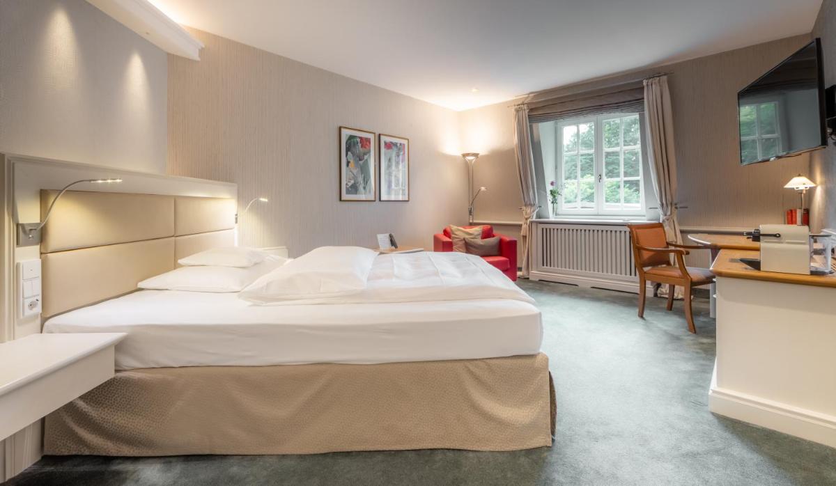 Ein Bett oder Betten in einem Zimmer der Unterkunft Waldhaus Reinbek