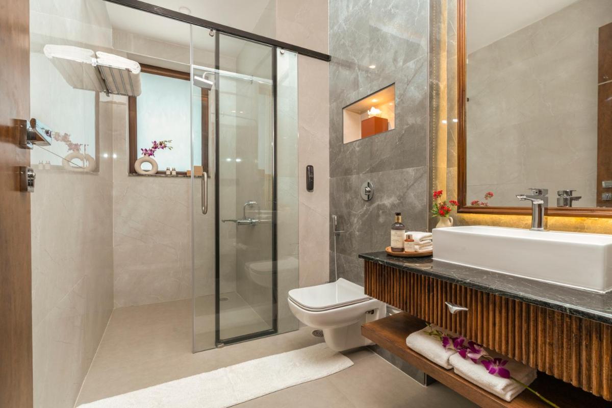 a bathroom with a sink toilet and a shower at ZANA Lakeview Resort - most scenic lakeside resort in Udaipur