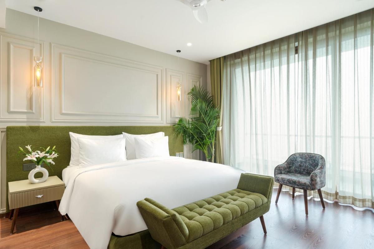 a bedroom with a large white bed and a chair at ZANA Lakeview Resort - most scenic lakeside resort in Udaipur
