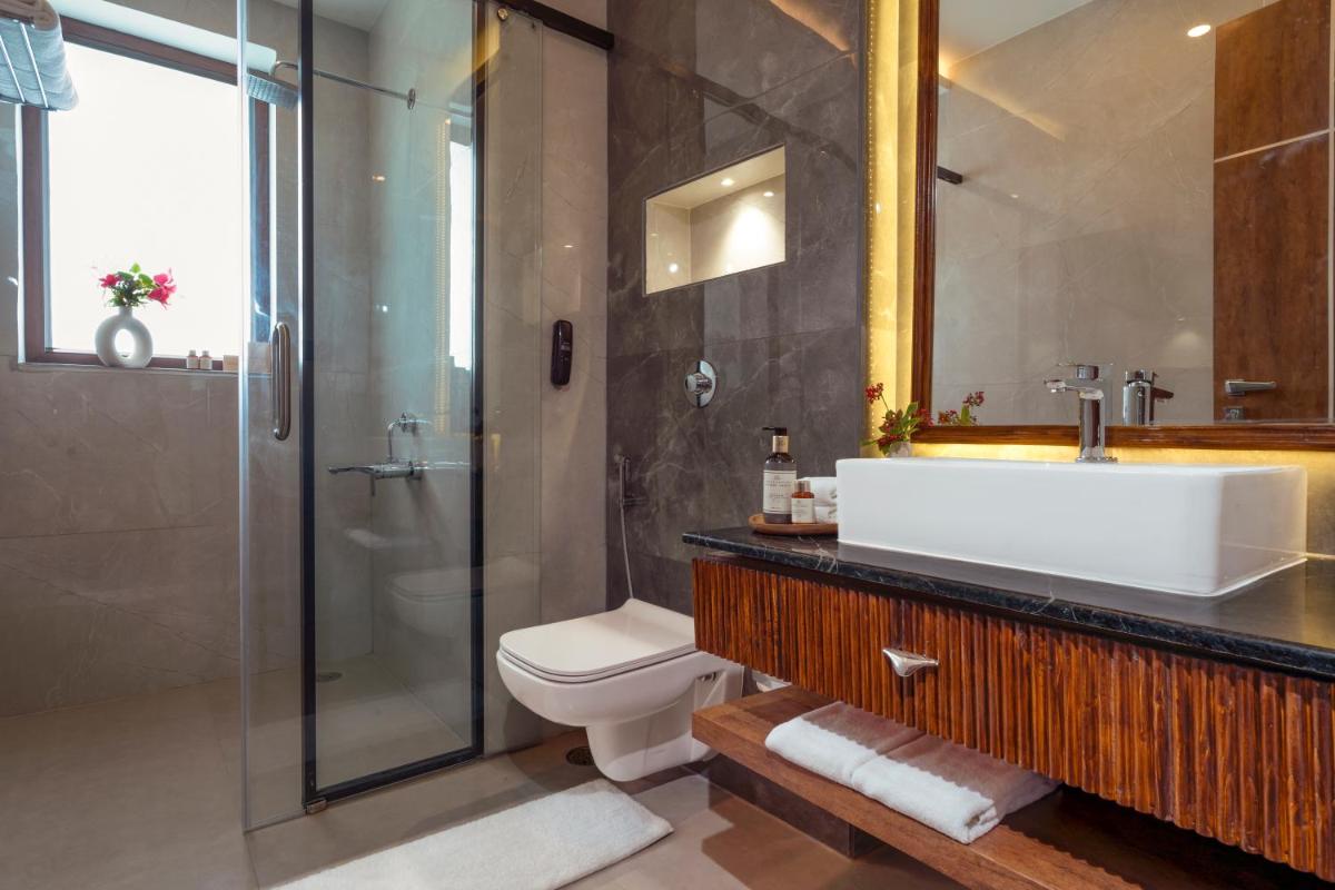 a bathroom with a sink and a shower and a toilet at ZANA Lakeview Resort - most scenic lakeside resort in Udaipur