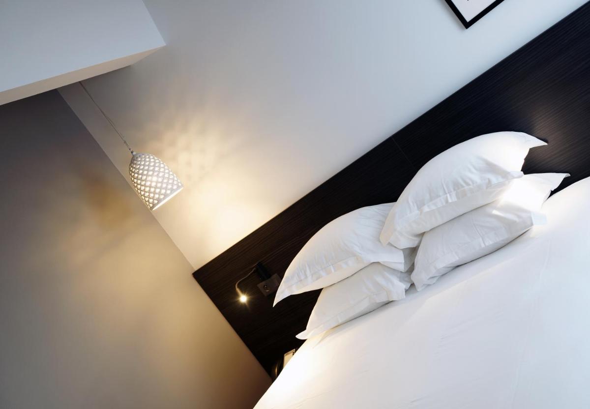 Un ou plusieurs lits dans un hébergement de l'établissement Alex Hotel & Spa