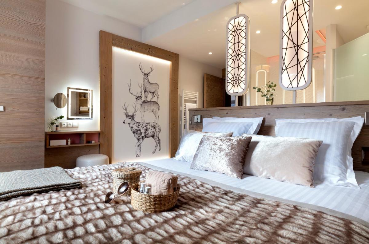 - une chambre avec un grand lit blanc et des oreillers blancs dans l'établissement Résidence Pierre & Vacances Premium L'Hévana, à Méribel