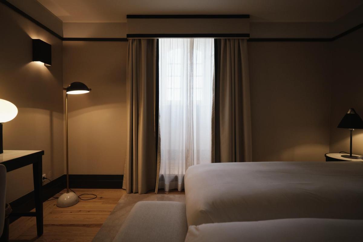 Uma cama ou camas num quarto em Octant Lousa
