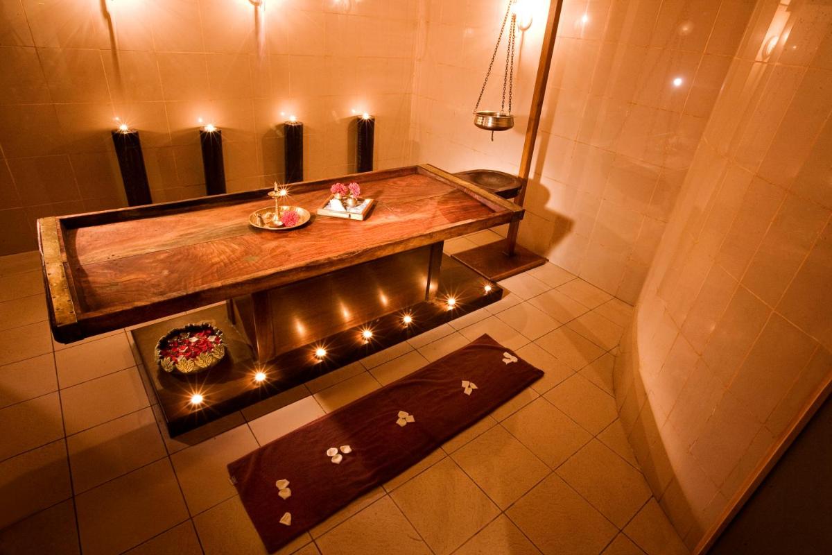 a bathroom with a wooden table with lights in it at The Grand New Delhi in New Delhi a bathroom with a wooden table with lights in it at The Grand New Delhi in New Delhi