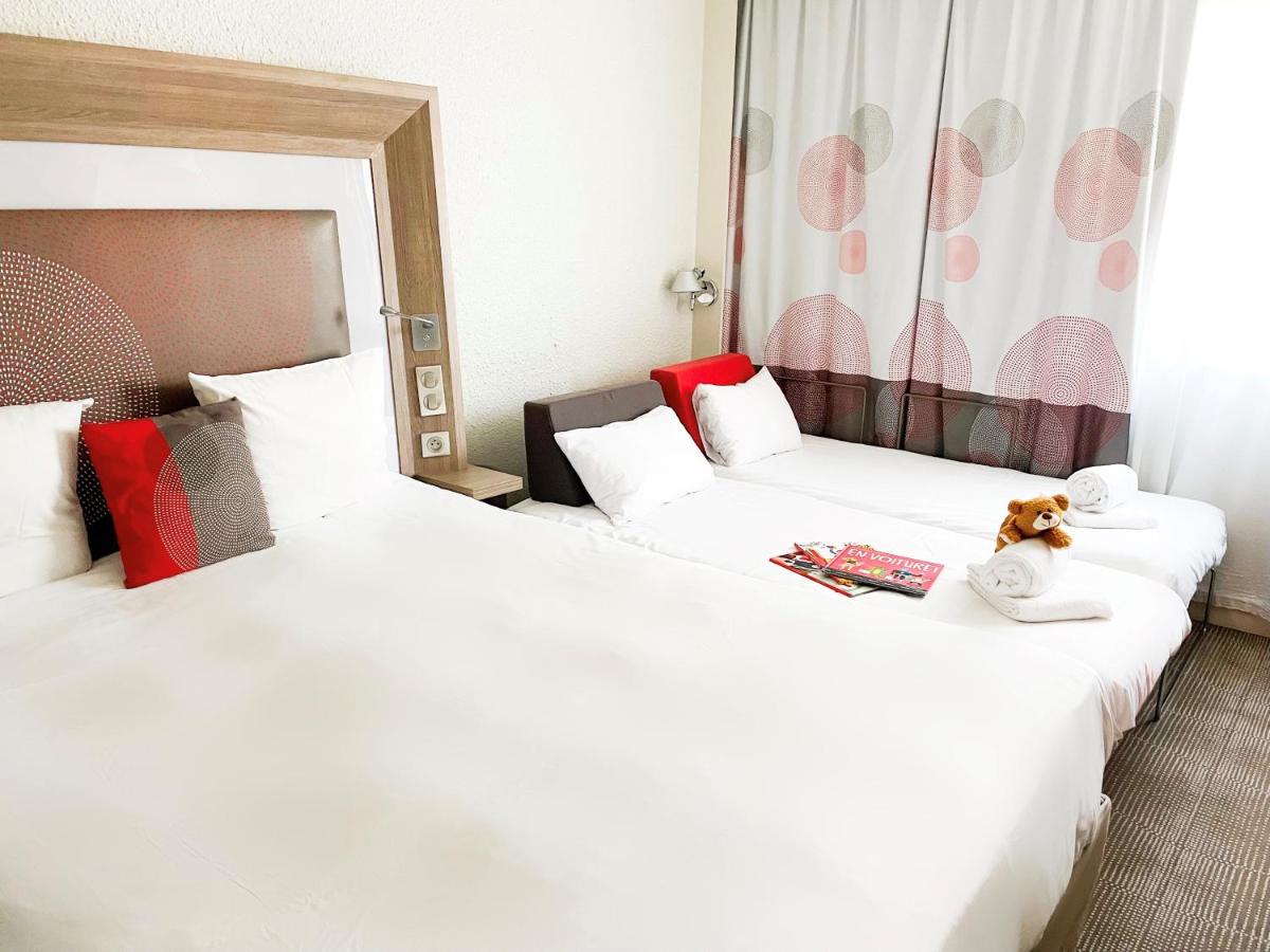 Un ou plusieurs lits dans un hébergement de l'établissement Novotel Fontainebleau Ury