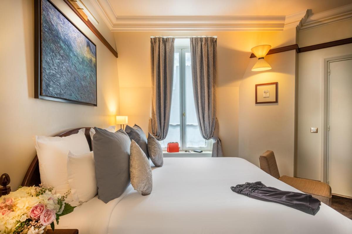 Un ou plusieurs lits dans un hébergement de l'établissement Hôtel Pont Royal Paris