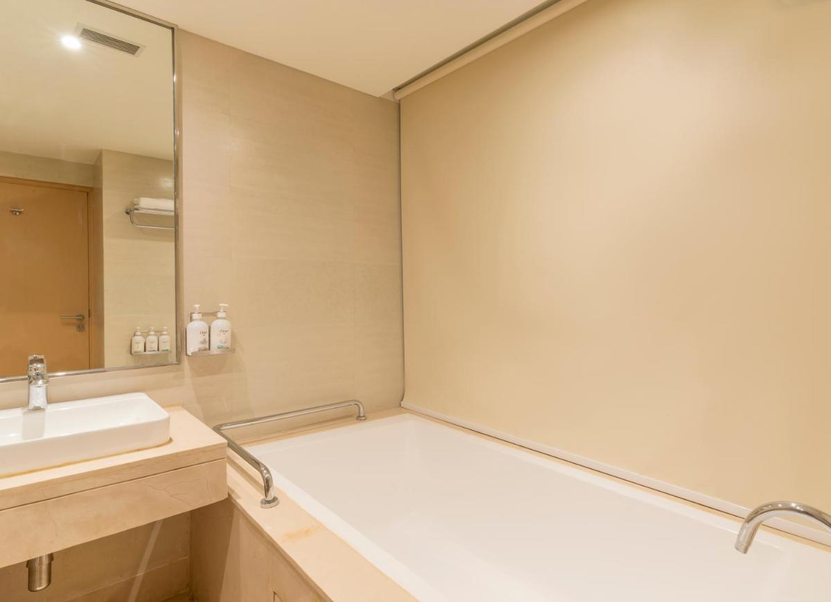 a bathroom with a sink and a mirror at Holiday Inn Agra MG Road an IHG Hotel in Agra