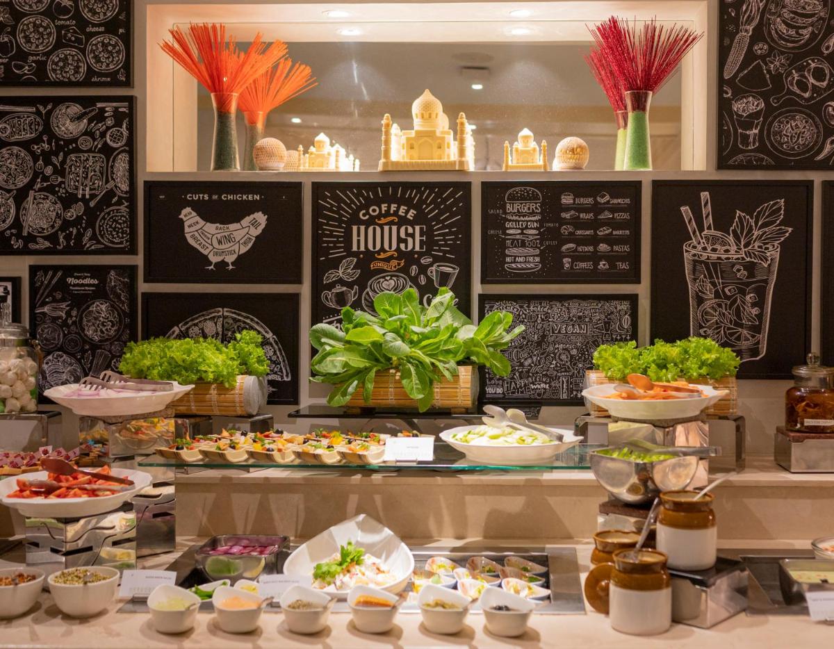 a buffet with many different types of food on display at Holiday Inn Agra MG Road an IHG Hotel in Agra