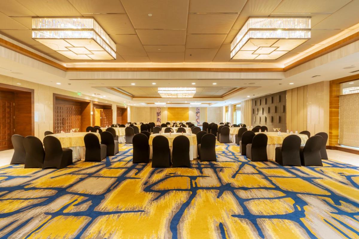 a large banquet hall with chairs and tables in a room at Holiday Inn Agra MG Road an IHG Hotel in Agra