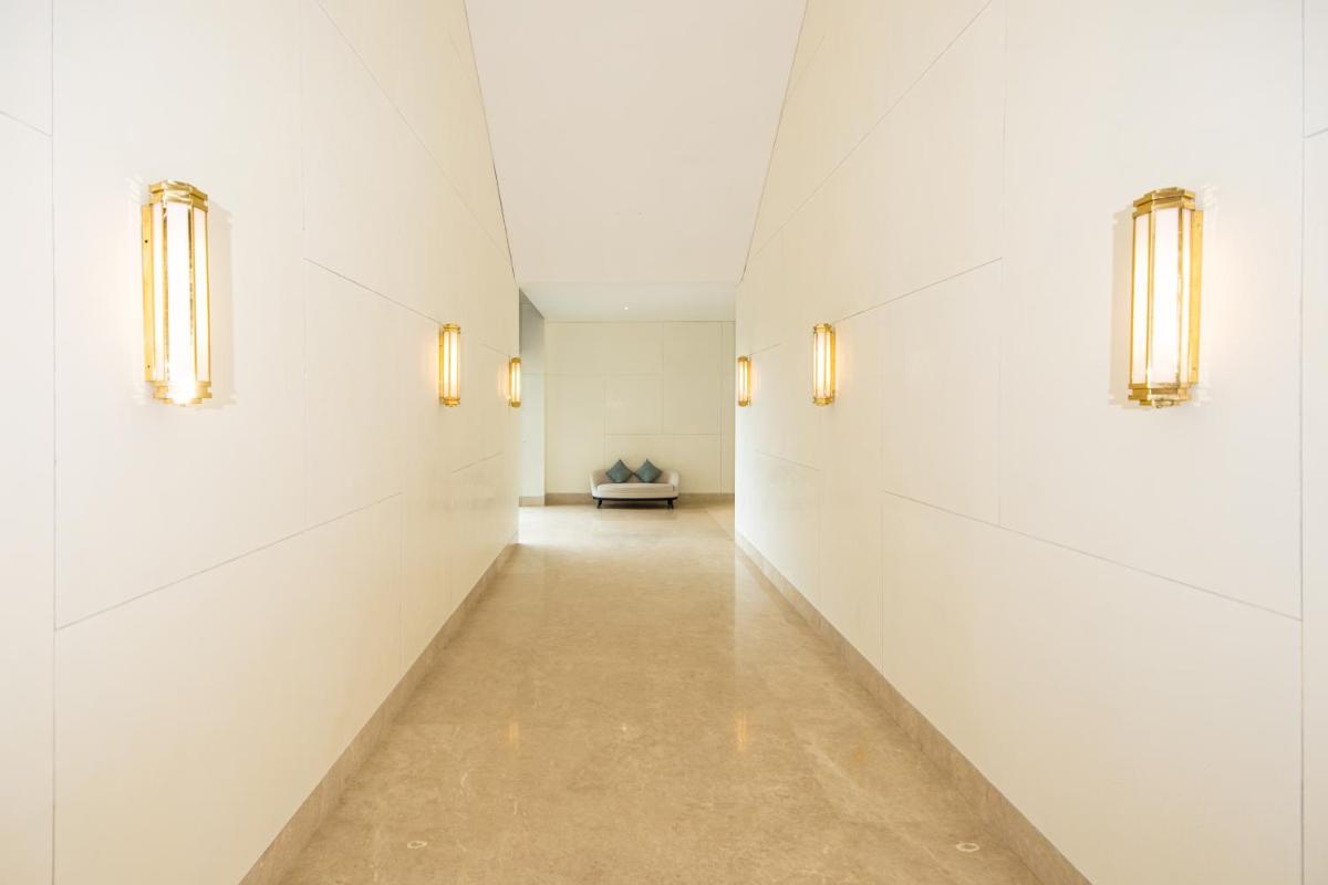 a hallway of an art gallery with lights on the walls at The Leela Bhartiya City Bengaluru in Bengaluru a hallway of an art gallery with lights on the walls at The Leela Bhartiya City Bengaluru in Bengaluru