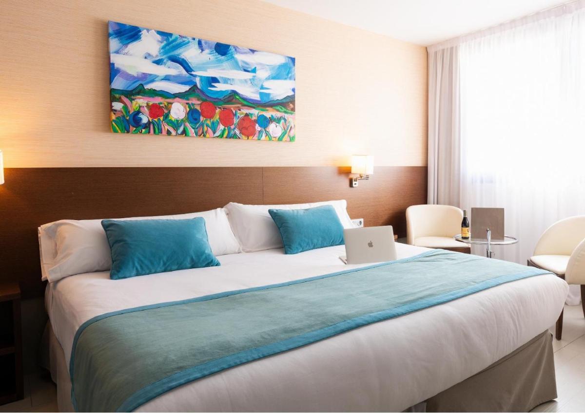 Cama o camas de una habitación en Hotel & Spa Real Ciudad De Zaragoza