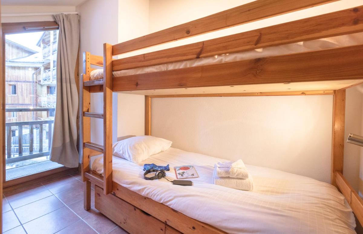 Un ou plusieurs lits dans un hébergement de l'établissement Résidence Club mmv Le Hameau des Airelles ****