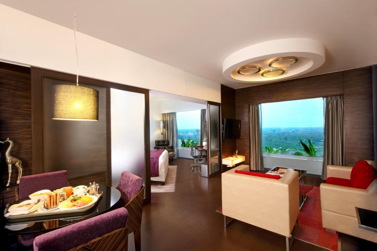 a room with a dining table and a living room at Fortune Select SG Highway, Ahmedabad - Member ITC Hotels' Group in Ahmedabad