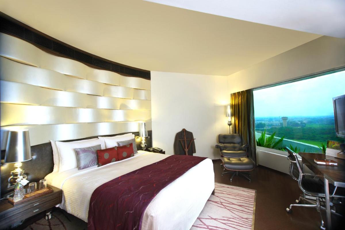 a hotel room with a large bed and a large window at Fortune Select SG Highway, Ahmedabad - Member ITC Hotels' Group in Ahmedabad