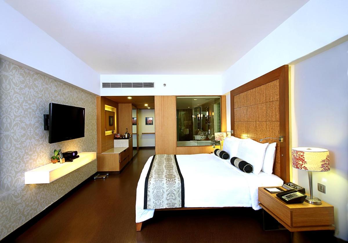 a hotel room with a bed and a television at Fortune Select SG Highway, Ahmedabad - Member ITC Hotels' Group in Ahmedabad