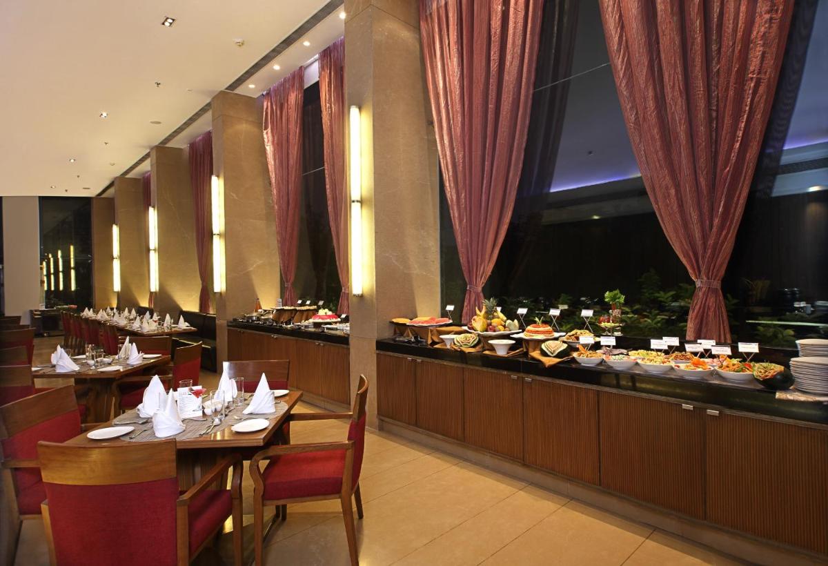 a restaurant with a buffet of food on a table at Fortune Select SG Highway, Ahmedabad - Member ITC Hotels' Group in Ahmedabad