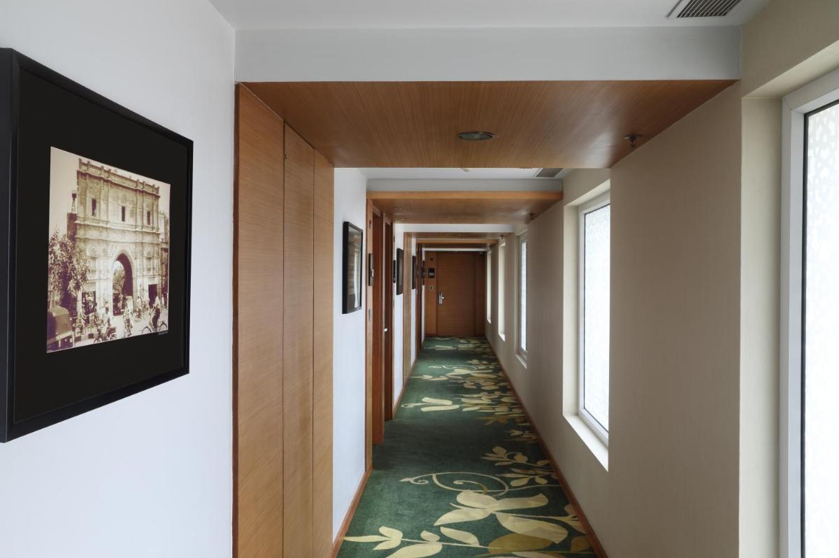 a hallway with a green carpet on the floor and windows at Fortune Select SG Highway, Ahmedabad - Member ITC Hotels' Group in Ahmedabad