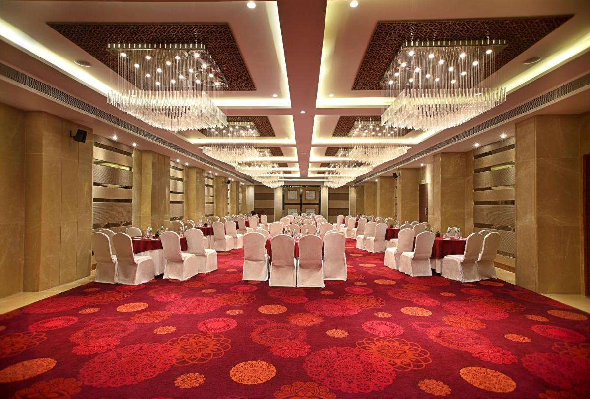 a conference room with white chairs and a red carpet at Fortune Select SG Highway, Ahmedabad - Member ITC Hotels' Group in Ahmedabad