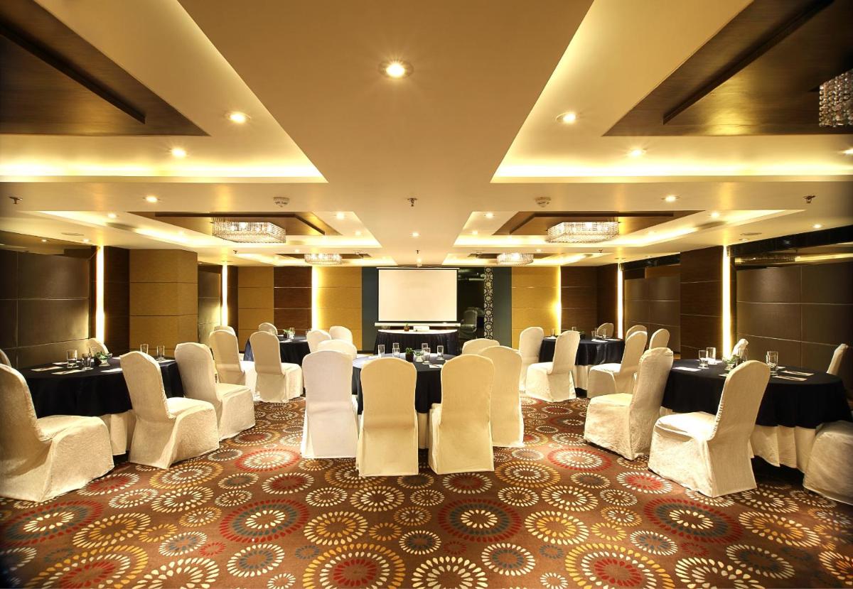 a conference room with a bunch of chairs and a screen at Fortune Select SG Highway, Ahmedabad - Member ITC Hotels' Group in Ahmedabad