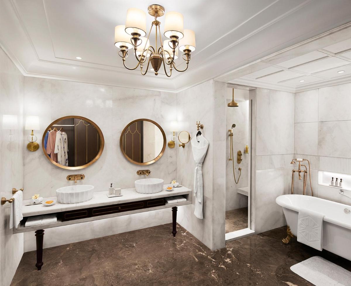 a bathroom with two sinks and a tub and a tubermott at Sawai Man Mahal in Jaipur