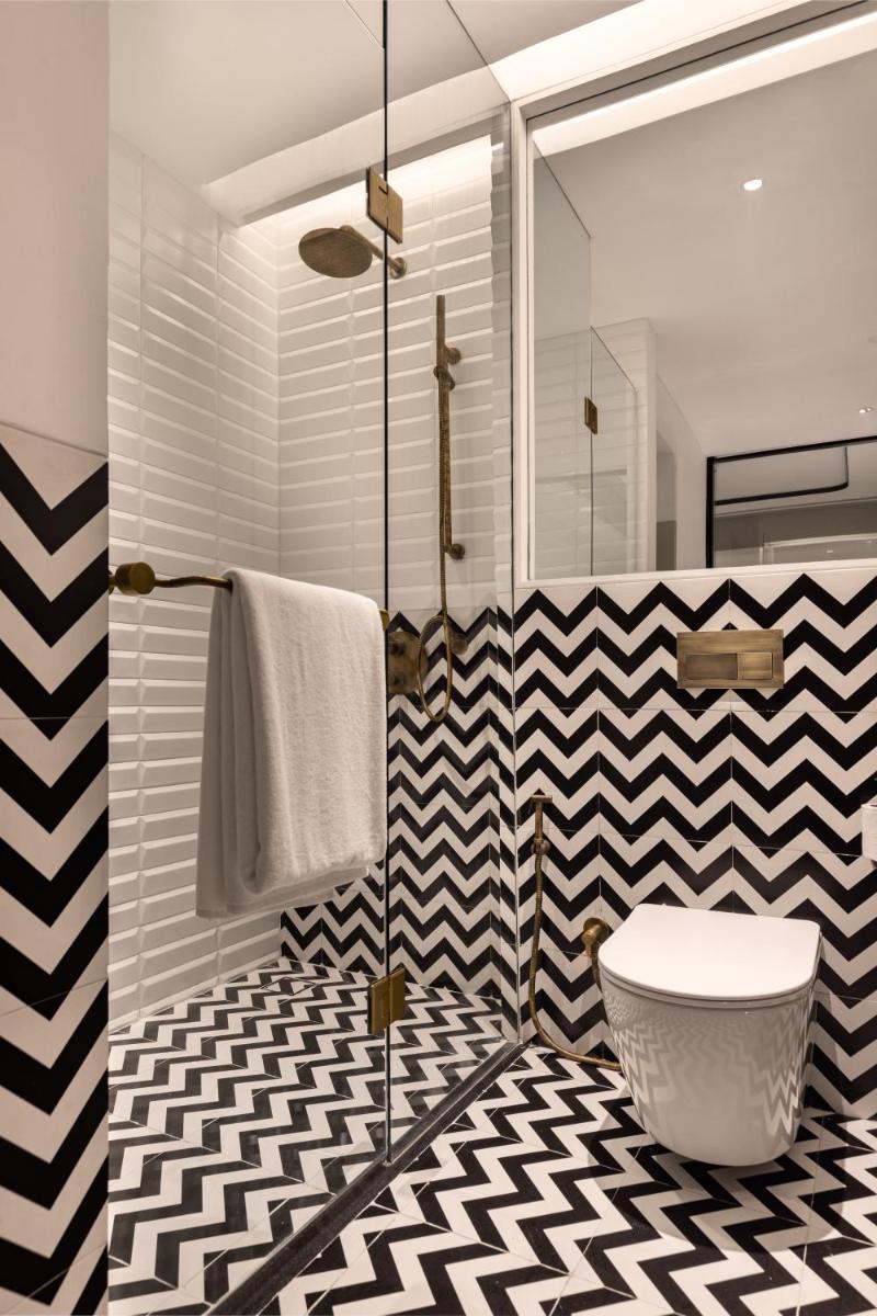 a bathroom with a black and white checkered floor at Hyatt Centric Sector17 Chandigarh in Chandīgarh