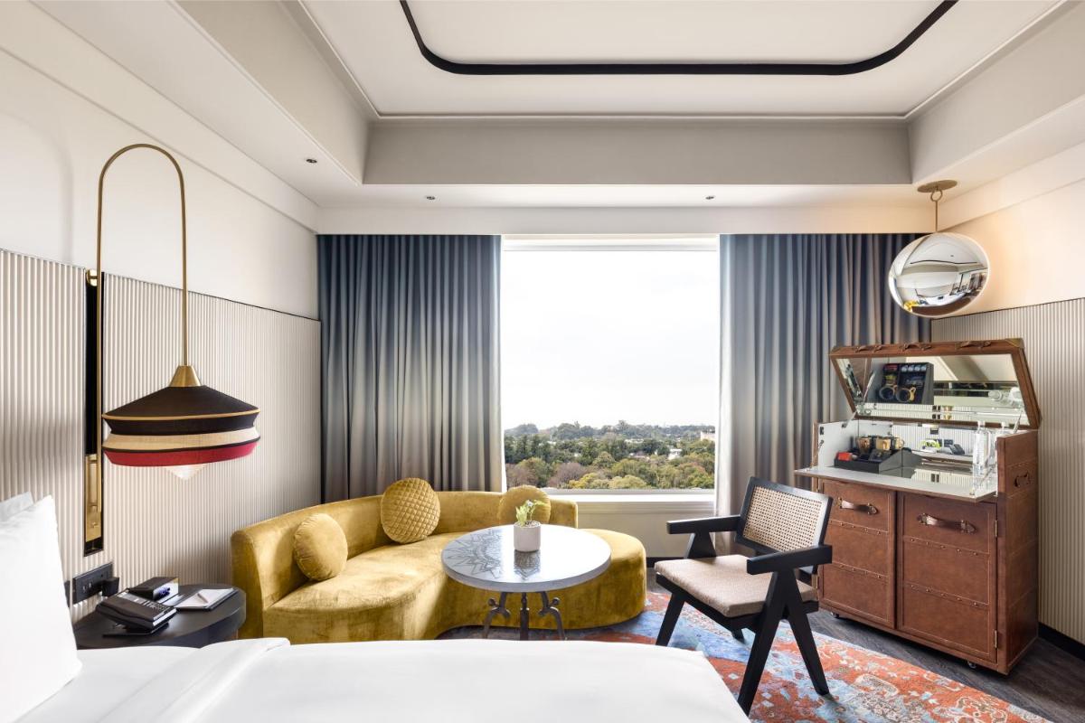a hotel room with a couch and a table at Hyatt Centric Sector17 Chandigarh in Chandīgarh