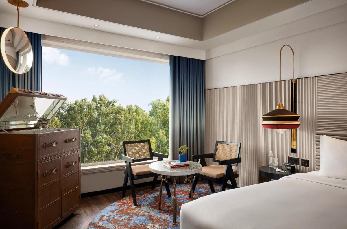 a hotel room with a bed and a table and a window at Hyatt Centric Sector17 Chandigarh in Chandīgarh