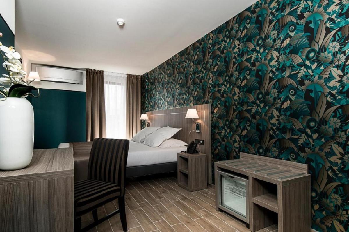 Un ou plusieurs lits dans un hébergement de l'établissement Unique Hôtel Résidence & Spa