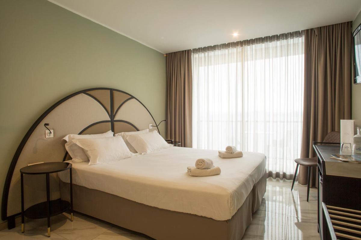 Un ou plusieurs lits dans un hébergement de l'établissement Hotel La Pietra Restaurant & Spa