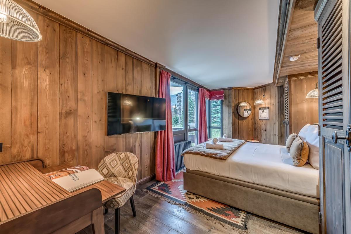 Un ou plusieurs lits dans un hébergement de l'établissement Hotel & Spa Le Val d'Isère
