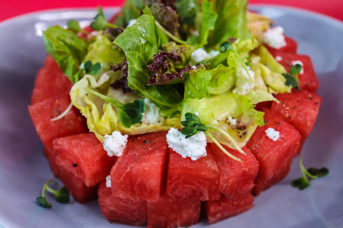 a plate with a salad with watermelon and lettuce at Radisson RED Chandigarh Mohali in Chandīgarh
