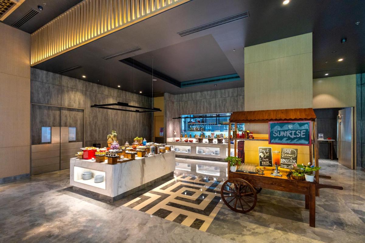 a restaurant with a food cart in a room at Radisson RED Chandigarh Mohali in Chandīgarh