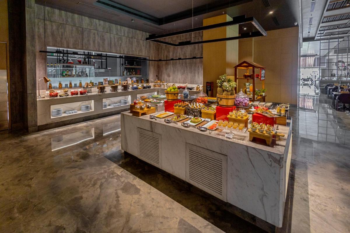 a buffet line with food on display in a store at Radisson RED Chandigarh Mohali in Chandīgarh