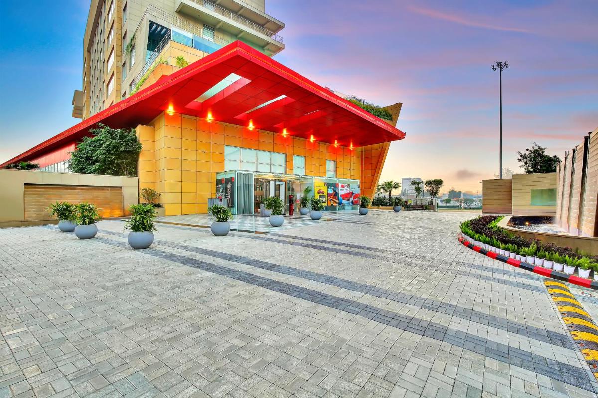 a building with a red roof on a street at Radisson RED Chandigarh Mohali in Chandīgarh