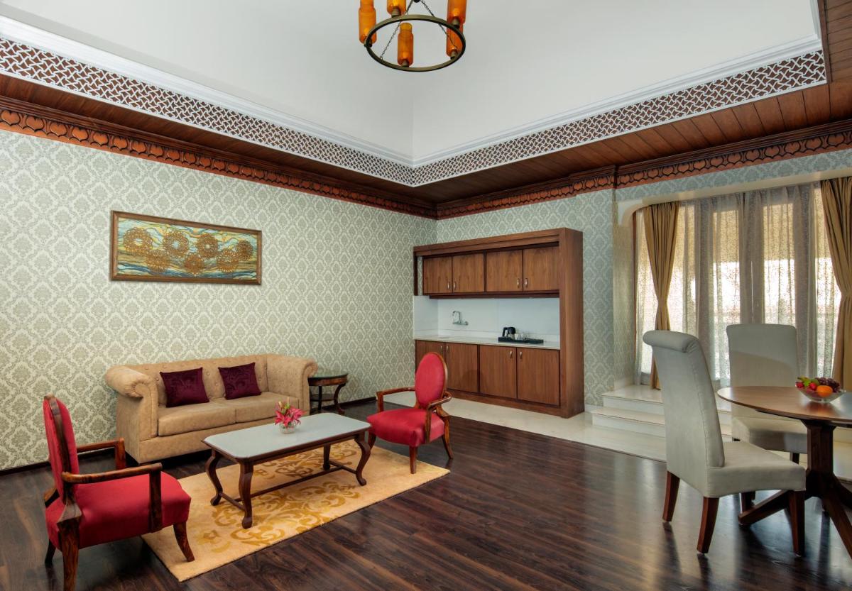 a living room with a couch and a table and chairs at Radisson Jodhpur in Jodhpur