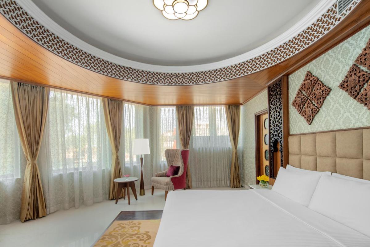 a hotel room with a bed and a chair at Radisson Jodhpur in Jodhpur