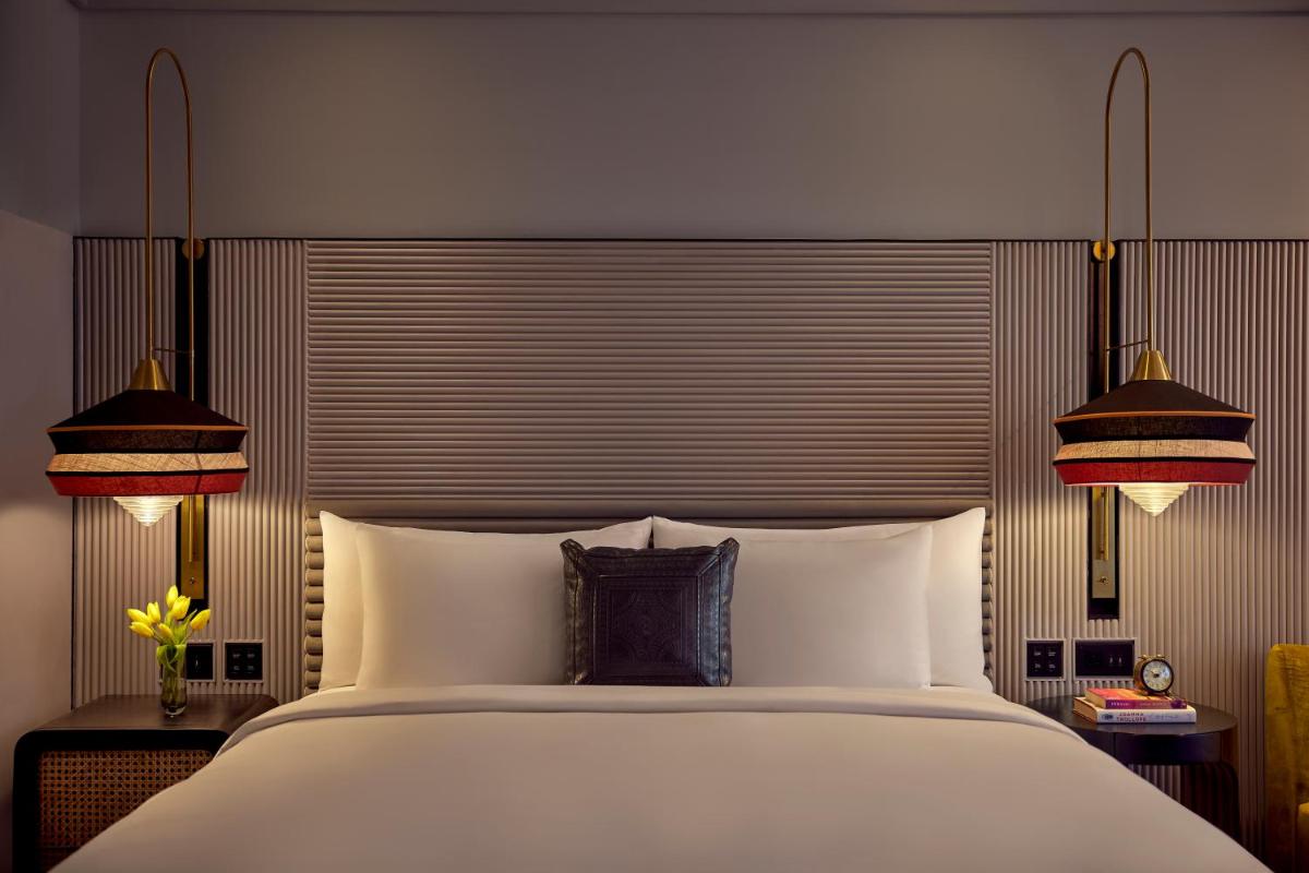 a bedroom with a large white bed with two lamps at Hyatt Centric Sector17 Chandigarh in Chandīgarh