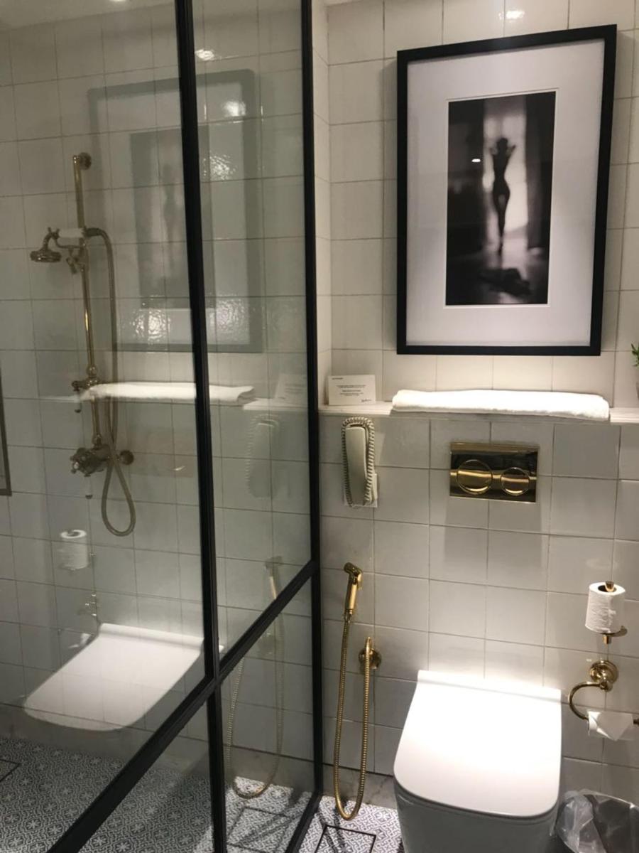 a bathroom with a shower and a toilet and a picture at Radisson Hotel Shimla in Shimla