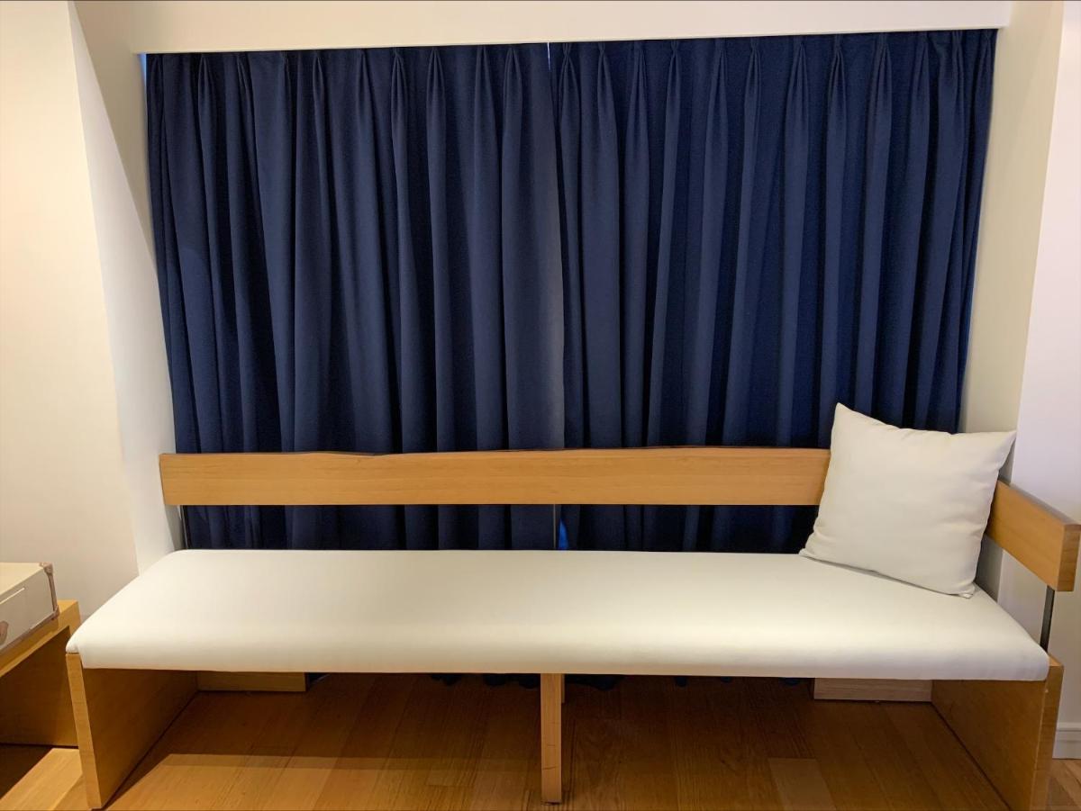a bench in front of a blue curtain at Radisson Hotel Shimla in Shimla