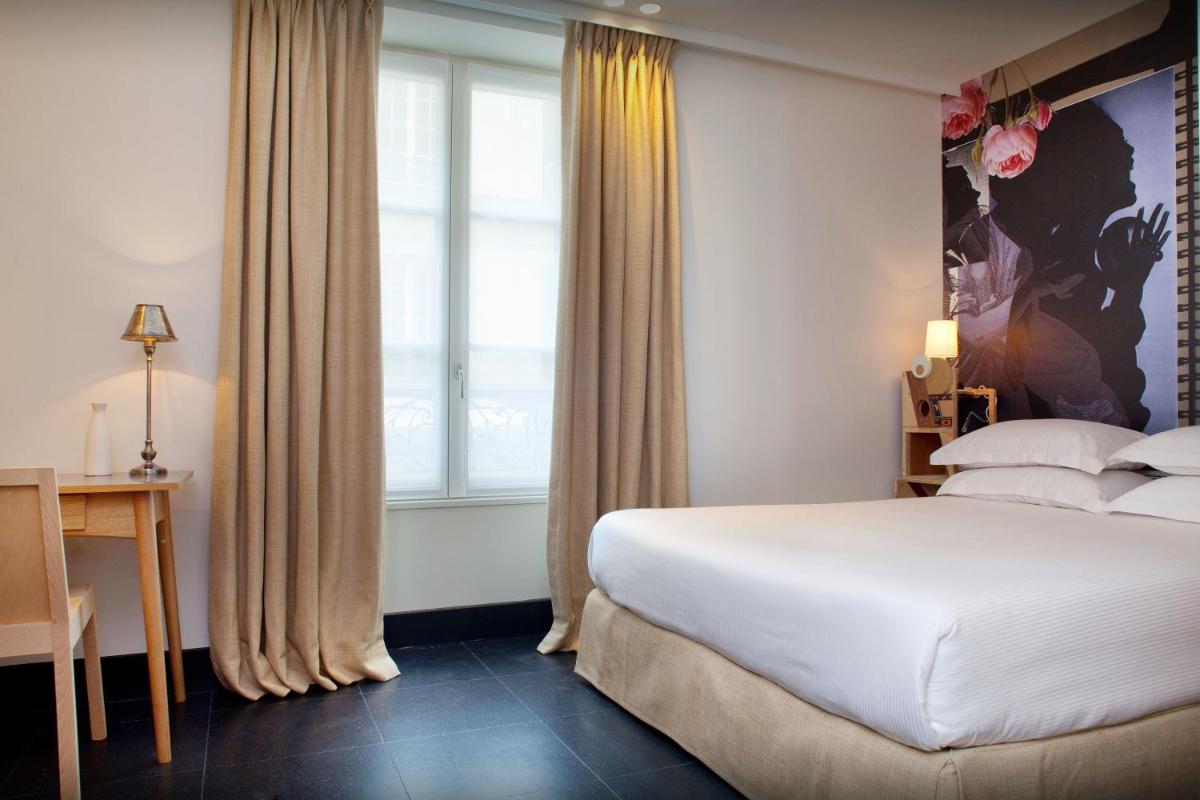 Un ou plusieurs lits dans un hébergement de l'établissement Hotel L’Antoine