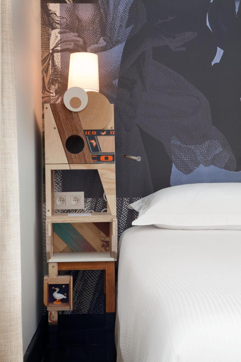 Un ou plusieurs lits dans un hébergement de l'établissement Hotel L’Antoine