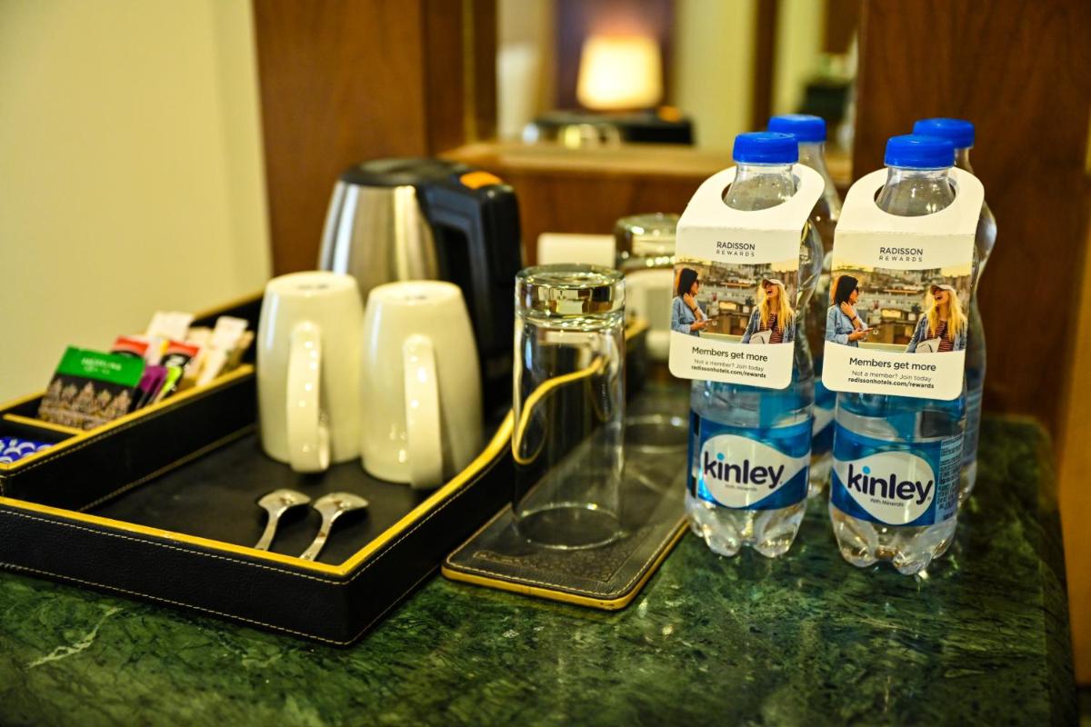 two bottles of water are sitting on a bathroom counter at Radisson Jodhpur in Jodhpur