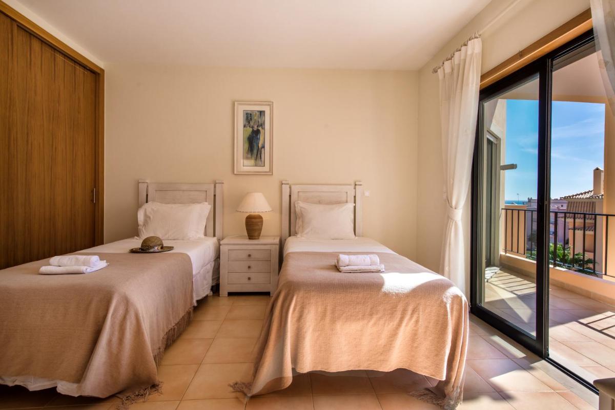 Uma cama ou camas num quarto em Estrela da Luz Resort
