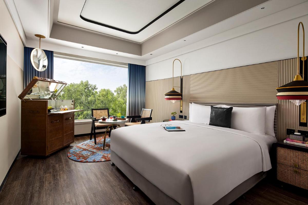 a bedroom with a large white bed and a desk at Hyatt Centric Sector17 Chandigarh in Chandīgarh