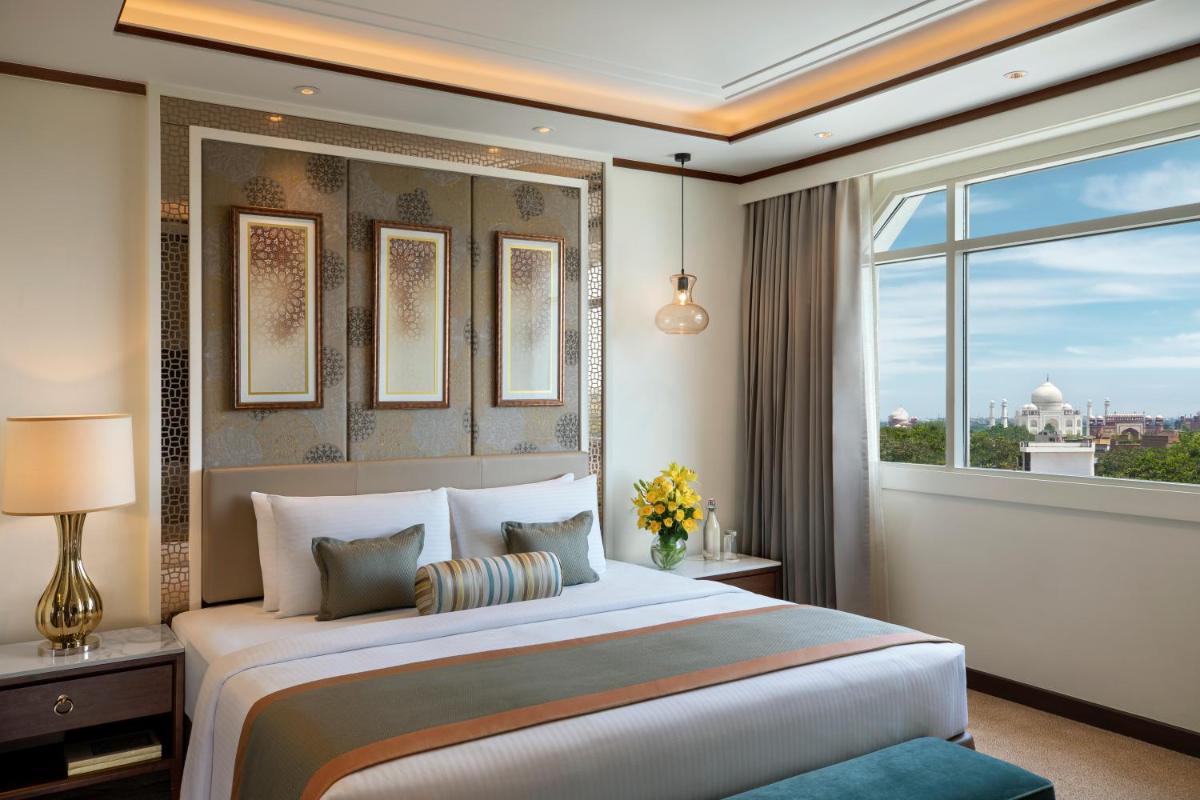 a bedroom with a large bed and a large window at Tajview, Agra-IHCL SeleQtions in Agra