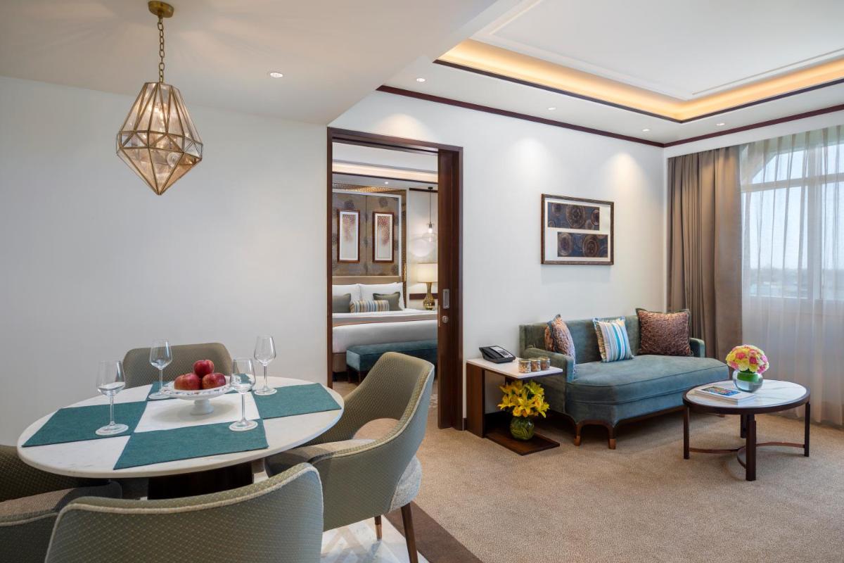 a living room with a dining table and a living room at Tajview, Agra-IHCL SeleQtions in Agra