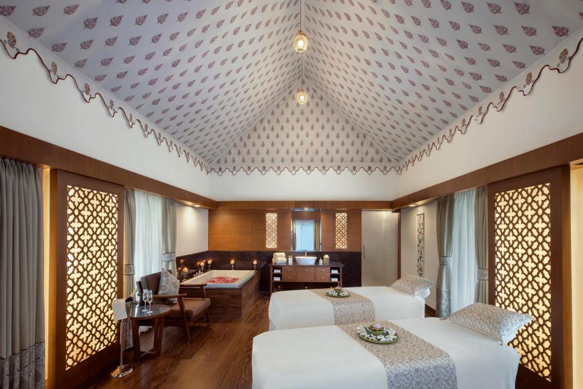 a hotel room with two beds and a living room at Tajview, Agra-IHCL SeleQtions in Agra